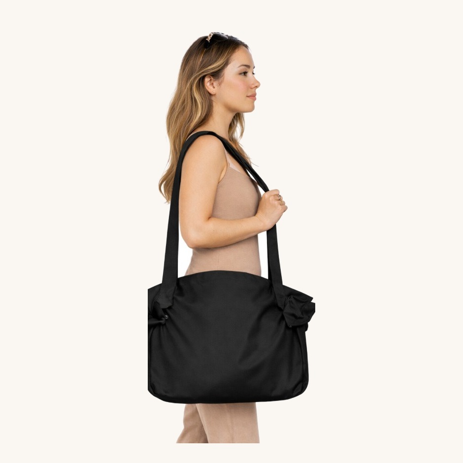The full bag carried on one shoulder while walking away